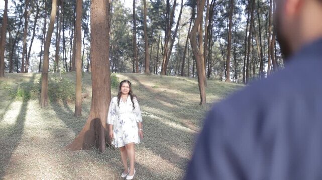 Romantic Couple Walking Together in a Serene Pine Forest During Daylight