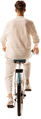 Rear view of young male cyclist riding bicycle isolated on transparent background. Concept of low carbon travel, personal freedom, active transportation.