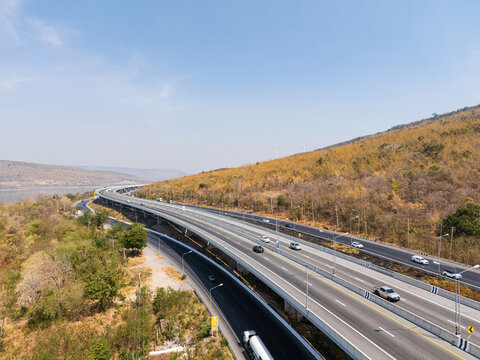Drone shot aerial view landscape of the M6  motorway Expressway Nakhon Ratchasima Province - Bang Pa-in. Lam Ta Khong River and Mountain. Drone shot of scenic landscape rural place traffic