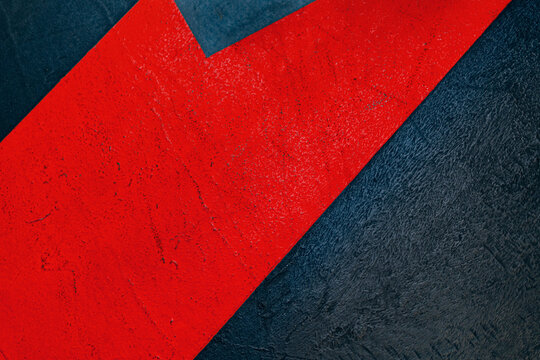 Abstract geometric bright red paint road marking on dark textured asphalt background
