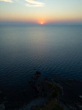 Drone Flying Forward Over Silistar Beach Bay at Golden Sunrise Sunset