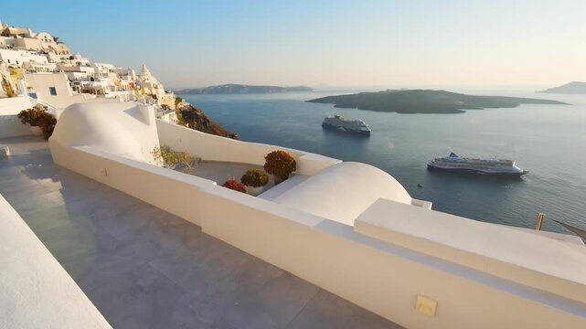 White architecture in Santorini island, Greece. Blue sea and the blue sky at sunset. Beautiful terrace with flowers. Travel and summer vacation concept. 
