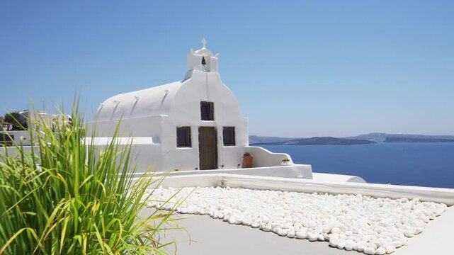 White architecture in Santorini island, Greece. Traditional greek church in Oia town. Blue sea and the blue sky at sunny day. Travel and summer vacation concept. 
