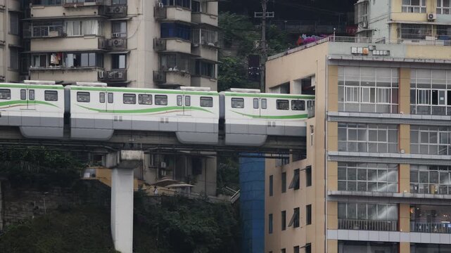 train enters liziba station inside a building on bridge in Chongqing china