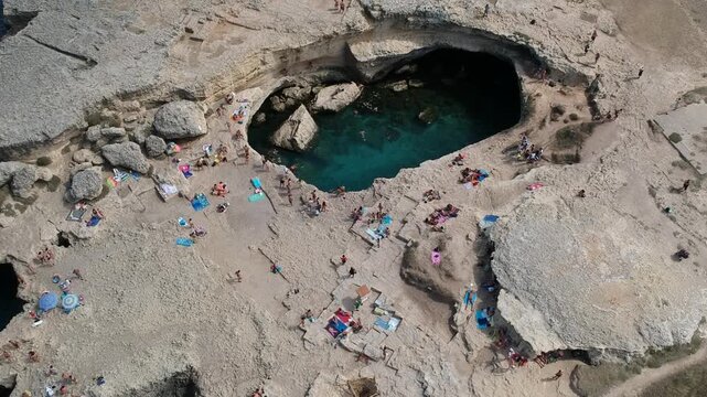 Aerial Drone View Inside Grotta della Poesia Sea Cave Entrance, Roca Vecchia, Ocean, Puglia, Italy