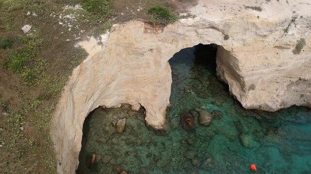 Puglia, Italy, Drone Footage of Torre Sant'Andrea Natural Arches and Turquoise Adriatic Waters, Sea, Ocean, Beach