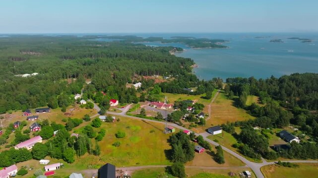 Aerial view rotating over the village on Hittinen island, summer day in Finland