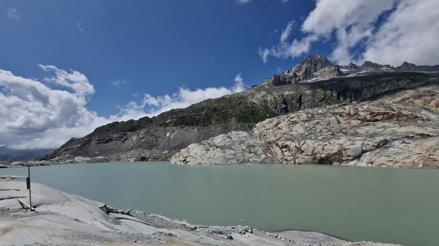 Scenic view of the melting rhone glacier creating a glacial lake in the swiss alps, switzerland
