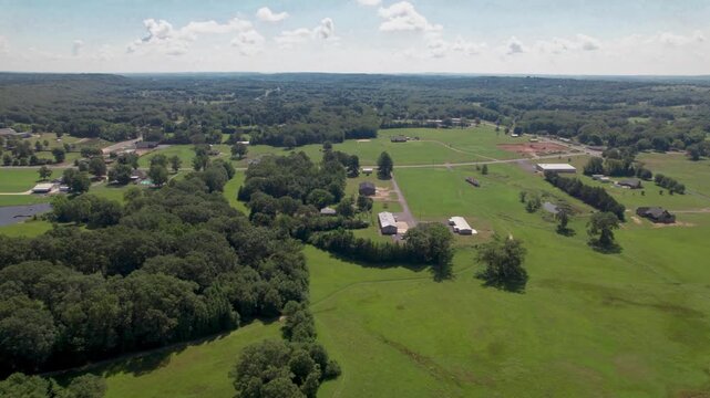 Aerial video of some fields and houses in Wooster Arkansas