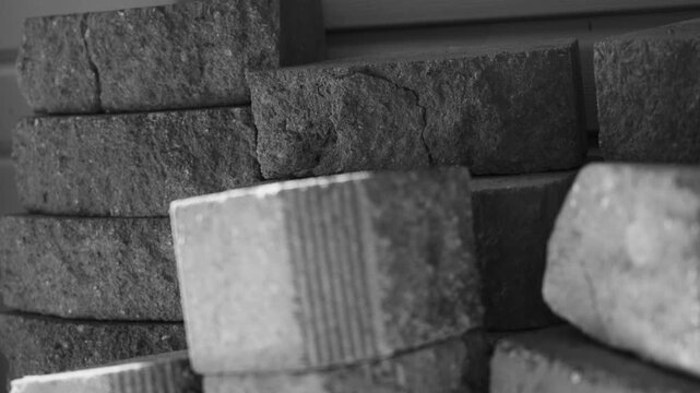Sloppy stacks of remaining bricks after a yardwork project.