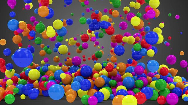 Colorful glossy balls fall, bounce, and pile up against a dark gray background in a playful abstract motion graphic, 3D animation