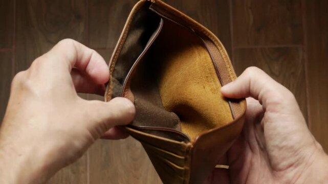 Bankrupt Man Looking at Empty Leather Wallet