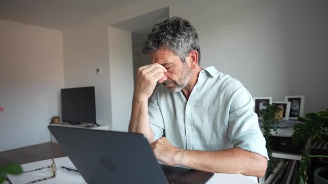 Stressed businessman receiving great news on his laptop