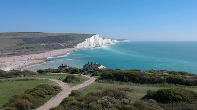 Drone View of Seven Sisters Chalk Cliffs and South Downs Countryside with a house, East Sussex, England