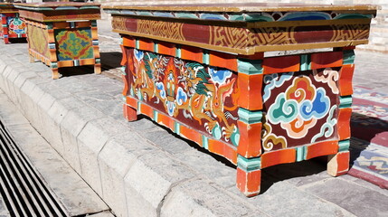 Traditional hand-painted Tibetan wooden tables with dragon motifs in Leh, Ladakh, India © Etoilepolaire