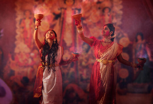 Bengali women performing dhunuchi dance on the occasion of Durga Puja