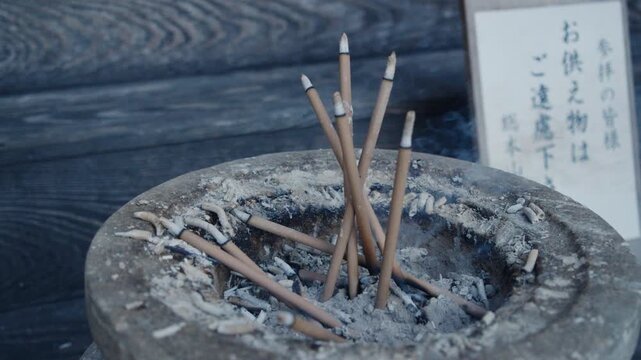 Incense sticks burning in a traditional japanese censer