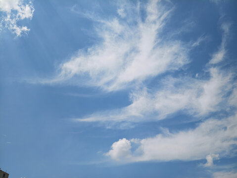 Wispy Cloud with Rich Texture & Tyndall Light Beams in the Blue Sky
