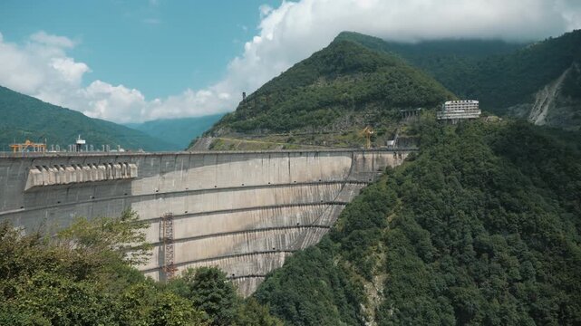 Enguri Arch Dam spanning mountain valley in Georgia, panoramic hydropower landmark for renewable electricity, civil engineering, water security, and industrial tourism.