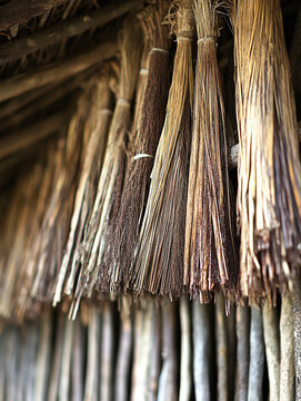 Detailed view of rustic thatched roofing with bundles of dried straw and wooden support beams