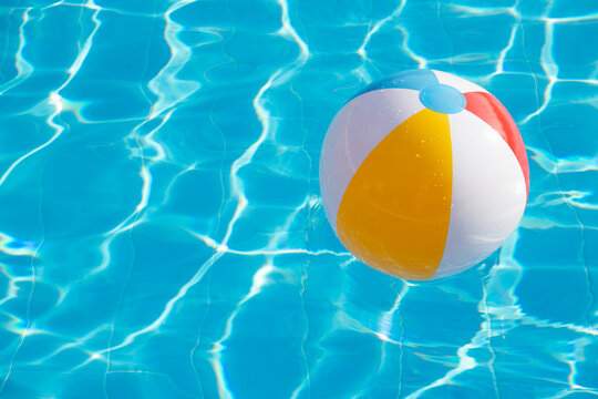 Colorful inflatable ball floating in swimming pool