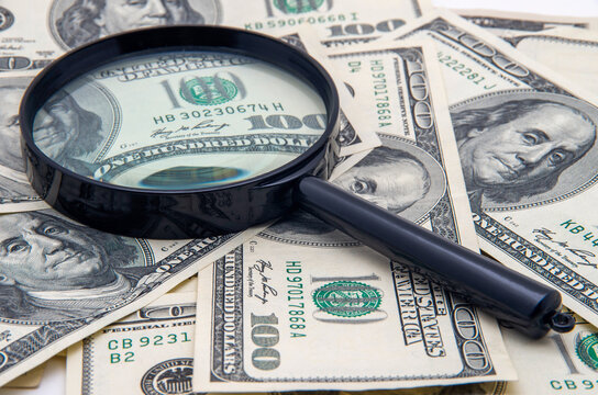 Magnifying glass and money - business background