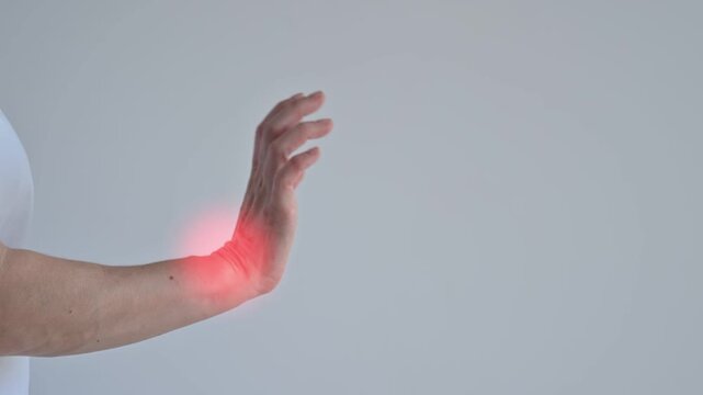 A woman suffers from wrist pain. The source of the pain is depicted as a red spot.