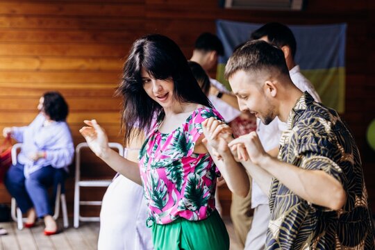 Multiple couples dancing bachata together at social dance event