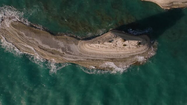 Top-down view revealing sculpted limestone layers carved by the Ionian Sea