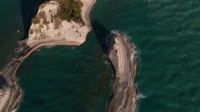 Graceful limestone forms carve emerald waters into a natural coastal masterpiece