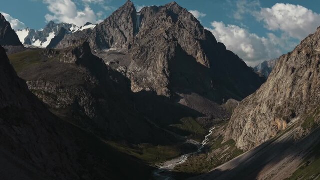 Close-up view of a majestic rocky mountain peak with patches of snow in Ala Archa National Park, Kyrgyzstan