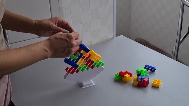 Building a colorful tower with blocks in a home setting