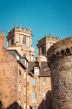 Historic stone towers and church spires against a blue sky, Rennes, France