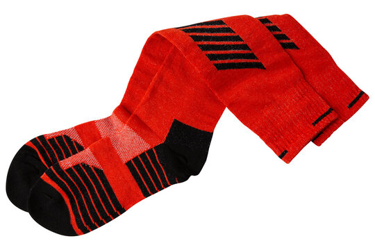 Pair of red athletic knee-high socks isolated on white background. Padded sport compression socks for skiing and football