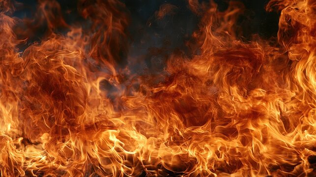 Intense, dynamic, fiery flames surge upwards against a dark backdrop, radiating heat