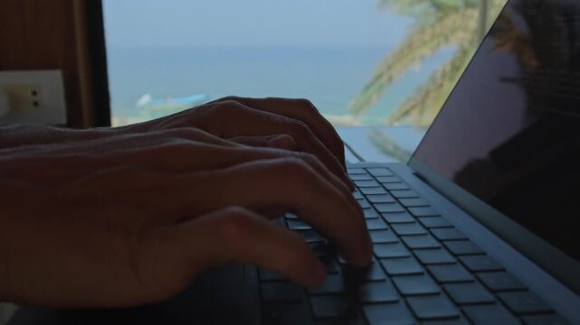 Deep work lifestyle close up of hands typing on laptop during focused work session in seaside coworking space showing distraction free productivity and intentional workflow