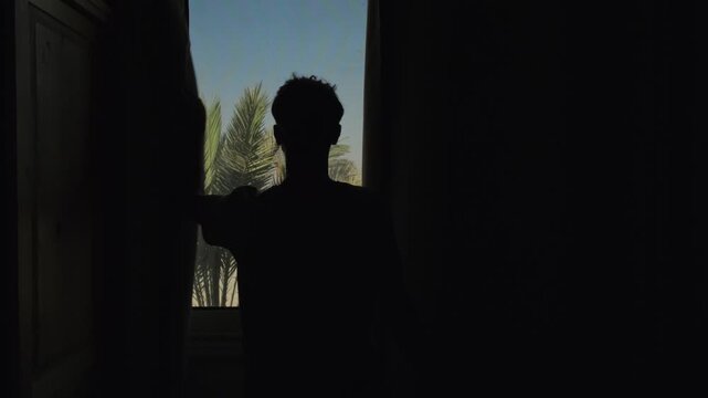 Travel in hot climate as traveler closes curtains to reduce intense sunlight while acclimatizing to high temperature and avoiding overheating during vacation stay