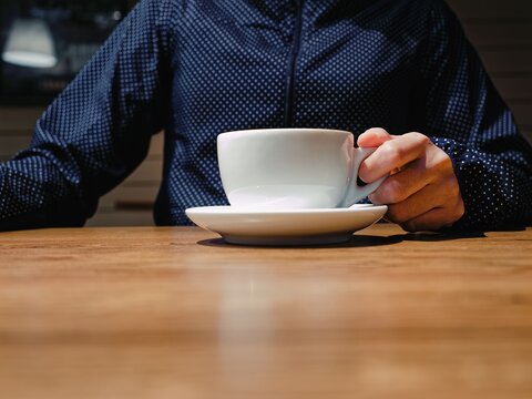 Coffee cup on table Hand holding coffee drink Cafe table Mock up blank logo 