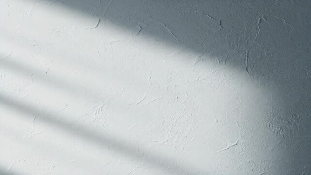 Abstract blue gray stucco texture wall background with natural sunlight and diagonal shadow overlay. Rough plaster surface backdrop for interior design or banner template.