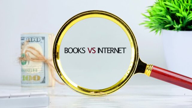 A magnifying glass shows the words books and internet while placed on a table with cash and a plant, highlighting a comparison in a study area