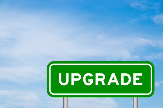 Green color transportation sign with word upgrade on blue sky with white cloud background