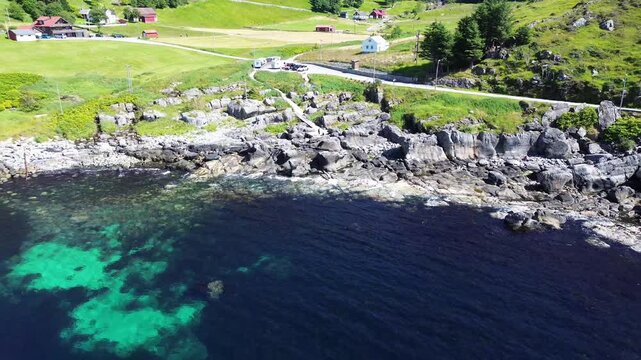 Drone Zoom Out Revealing Kannesteinen Sea Stack on Norway&rsquo;s Coast