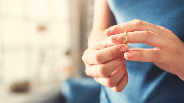 Woman takes off an wedding ring