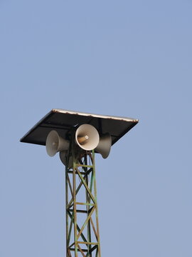 Mosque Loudspeaker Mounted on Tower Against Blue Sky