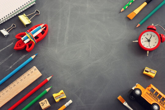 Back to school concept over classroom blackboard. Top view