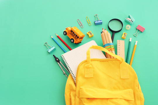 Back to school concept over pastel background. Top view