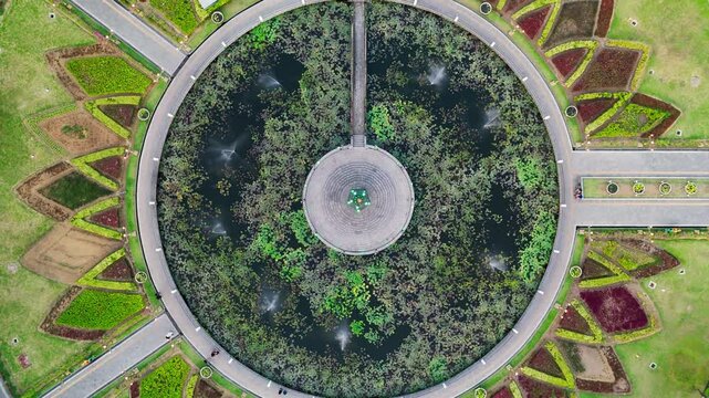 Aerial view of the circular pond and gardens at Alun Alun Tugu Malang with fountains and pathways in Malang, East Java, Indonesia.
