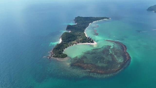 Aerial view of Koh Madsum island surrounded by turquoise waters and coral reefs in Koh Samui, Chang Wat Surat Thani, Thailand.
