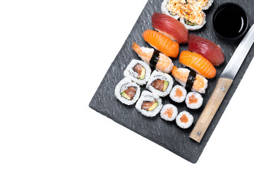 Assorted sushi platter with nigiri, maki and uramaki isolated on white background. Top view. Copy space © chandlervid85