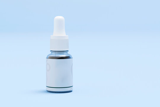 Glass dropper bottle with pipette on blue background